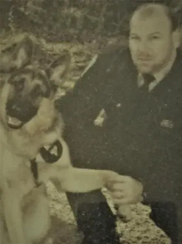 Officer shaking paw with canine companion