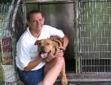 Person with dog near a kennel
