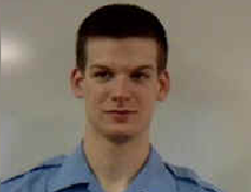 Man standing against a plain background