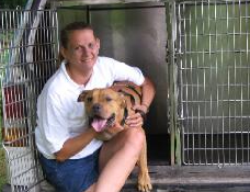Person with dog near a kennel