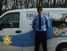 Uniformed officer with animal control vehicle